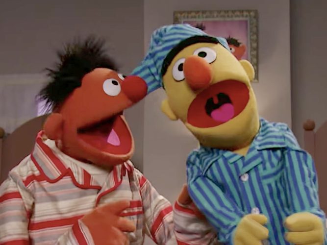 Bert and Ernie singing in their pajamas.