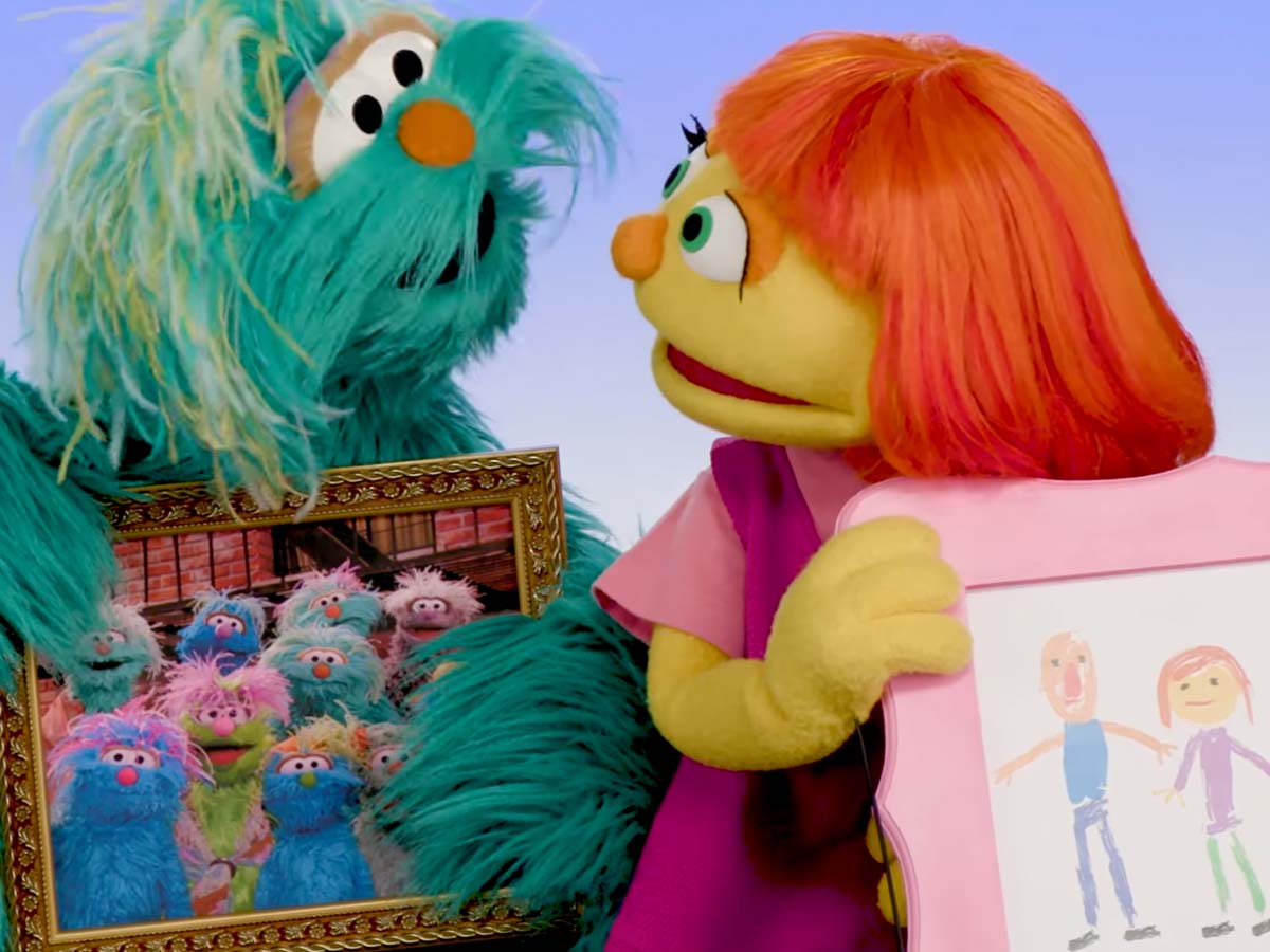 Rosita and Julia holding family portraits.