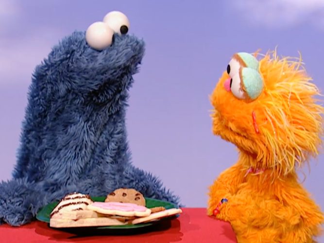 Zoe and Cookie Monster stare at each other