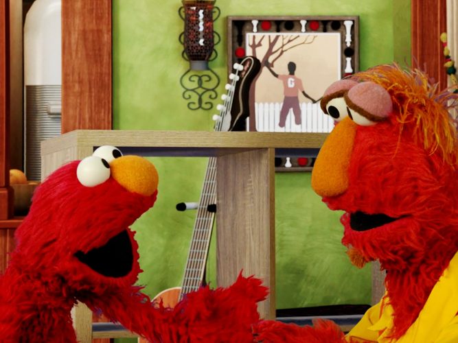 Elmo excitedly talking to his dad.