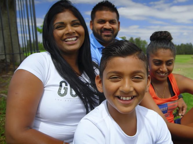 A family of four smiling.