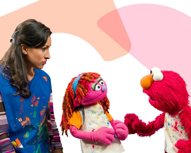 Sophia, Lily, and Elmo in painting smocks.