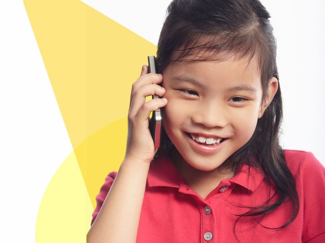 A child speaks on a smartphone