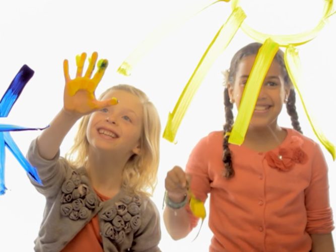 Two kids finger painting.