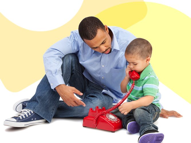 A child playing on a phone with a caregiver.