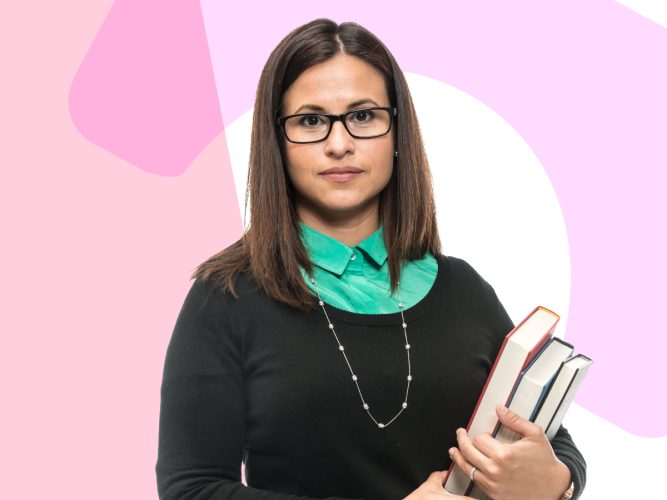 A teacher holding books.