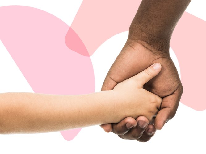 Close up of two hands clasping.