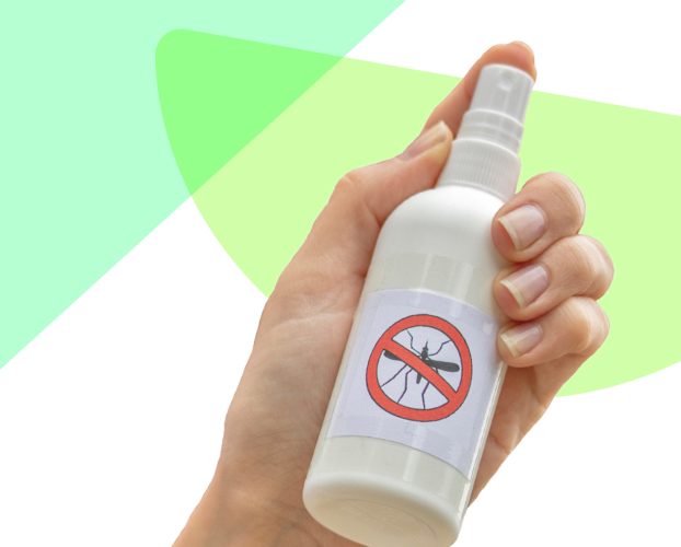 A hand holding bug spray