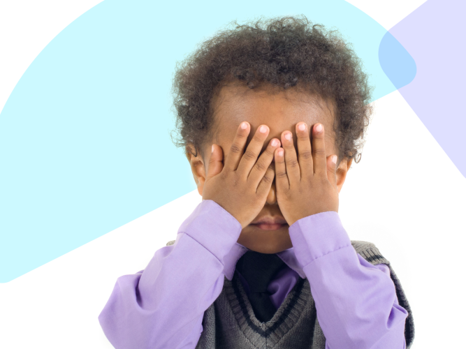 Child with their eyes covered.