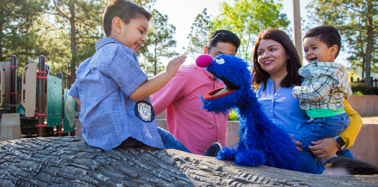 Grover outside with a family.