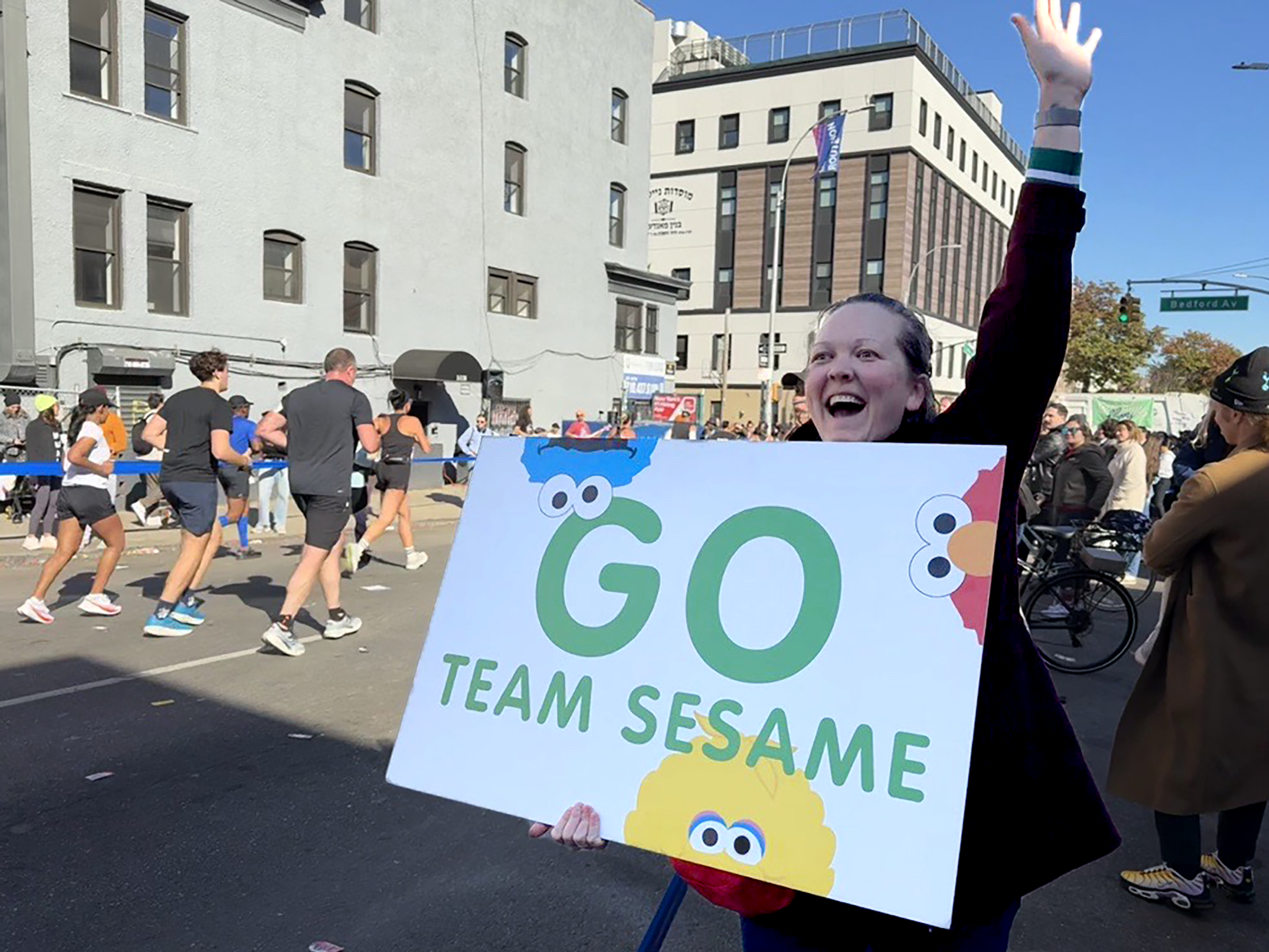 A bystander cheering for the NY marathon with a