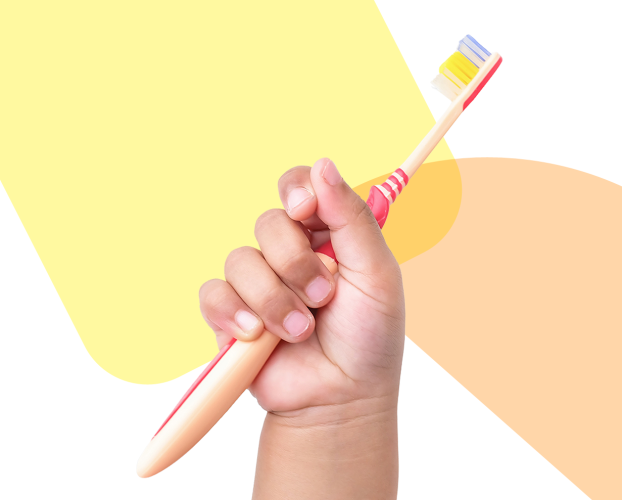 A hand holding a toothbrush.