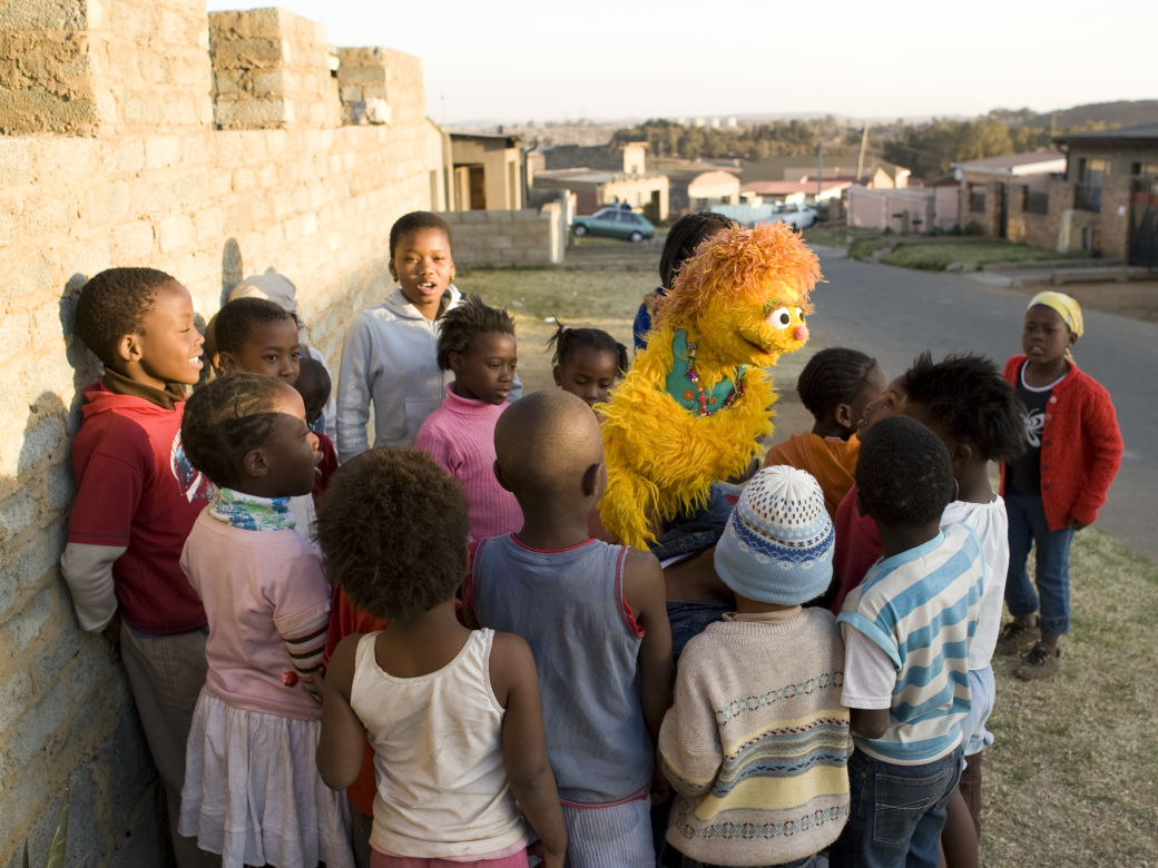 Kami plays with a group of children