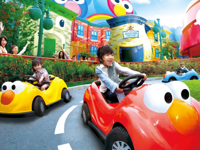 Two kids playing with a toy car.