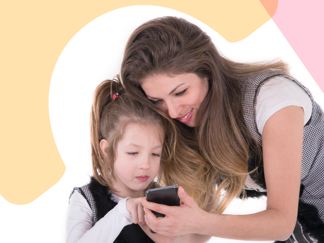 A parent showing her child something on a a phone.